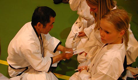 Sensei T. Watanabe signing belts for the kids